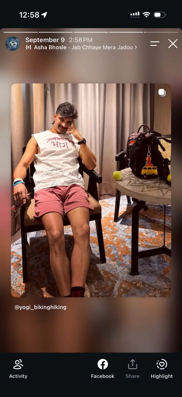 A Story repost of a member in the भाग Muscle Tank and pink shorts, sitting in a hotel room
