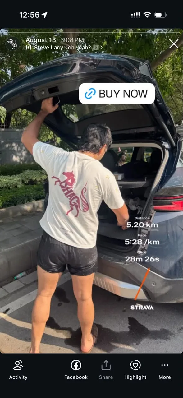 A member's Story of a post-run car park moment in the Wild Strides Tee in Ivory, rearing horse print on the back, with a Strava card for 5.20 km