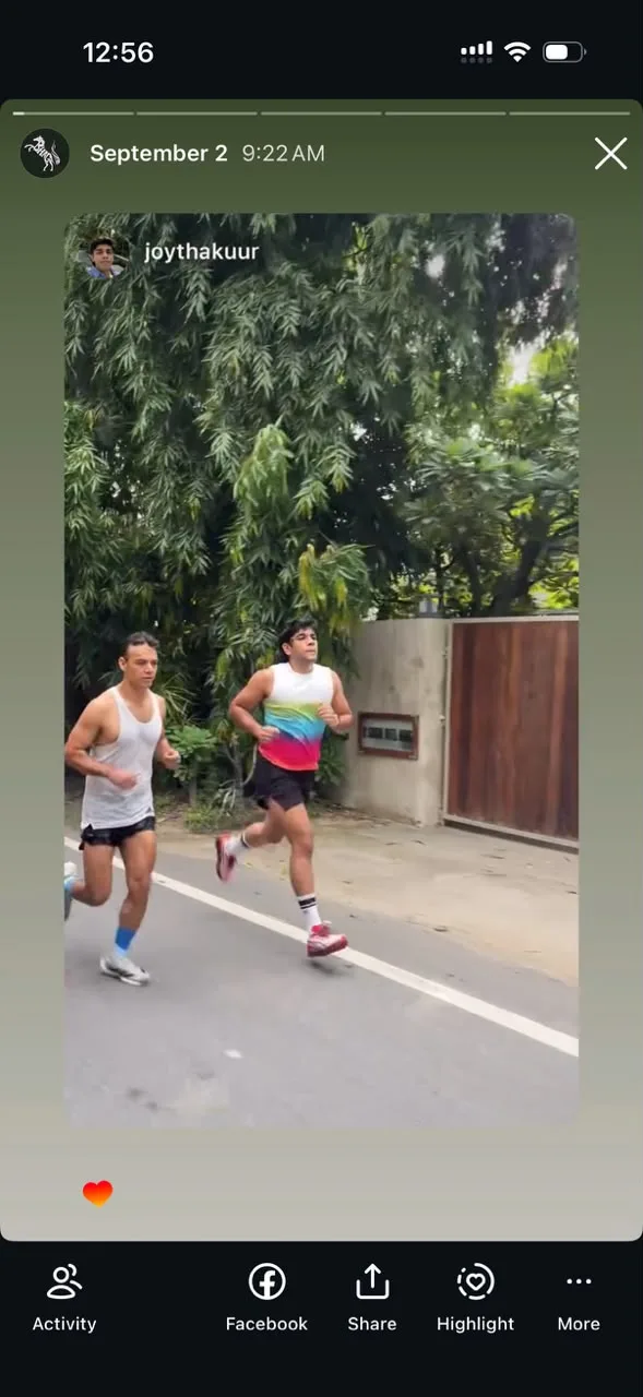 A friend's Story of two runners on a tree-lined road, one in the Bright Aura Vest