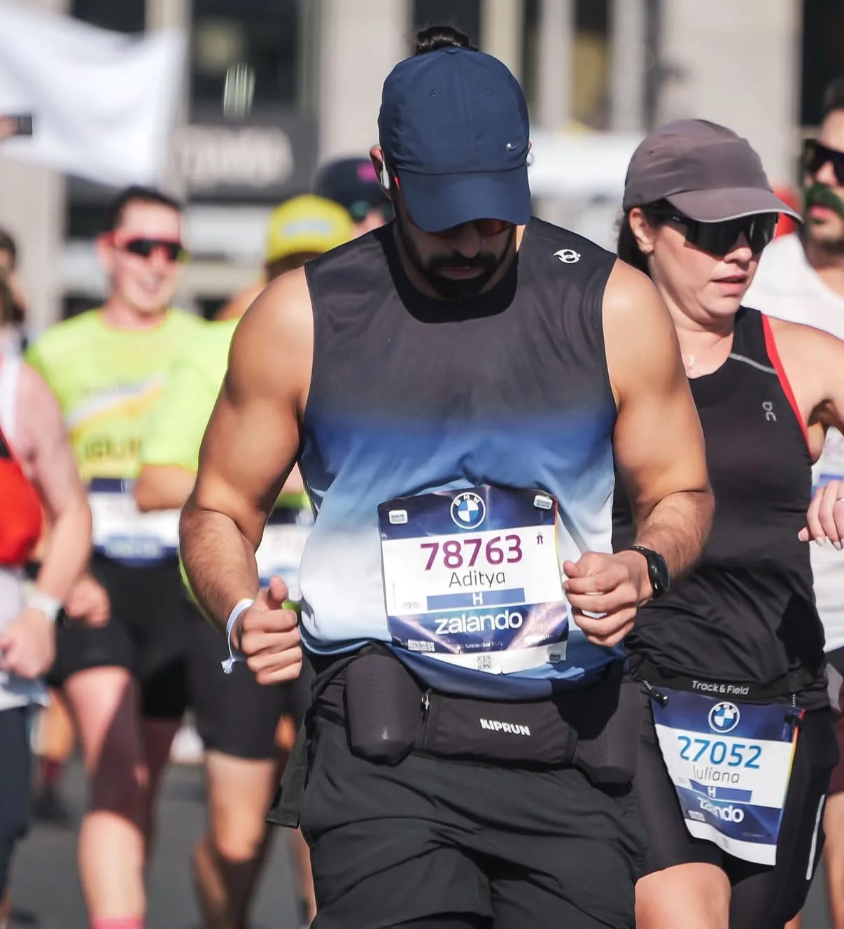 Close-up of the Dark Aura Vest's blue ombre mid-stride at the Berlin Marathon