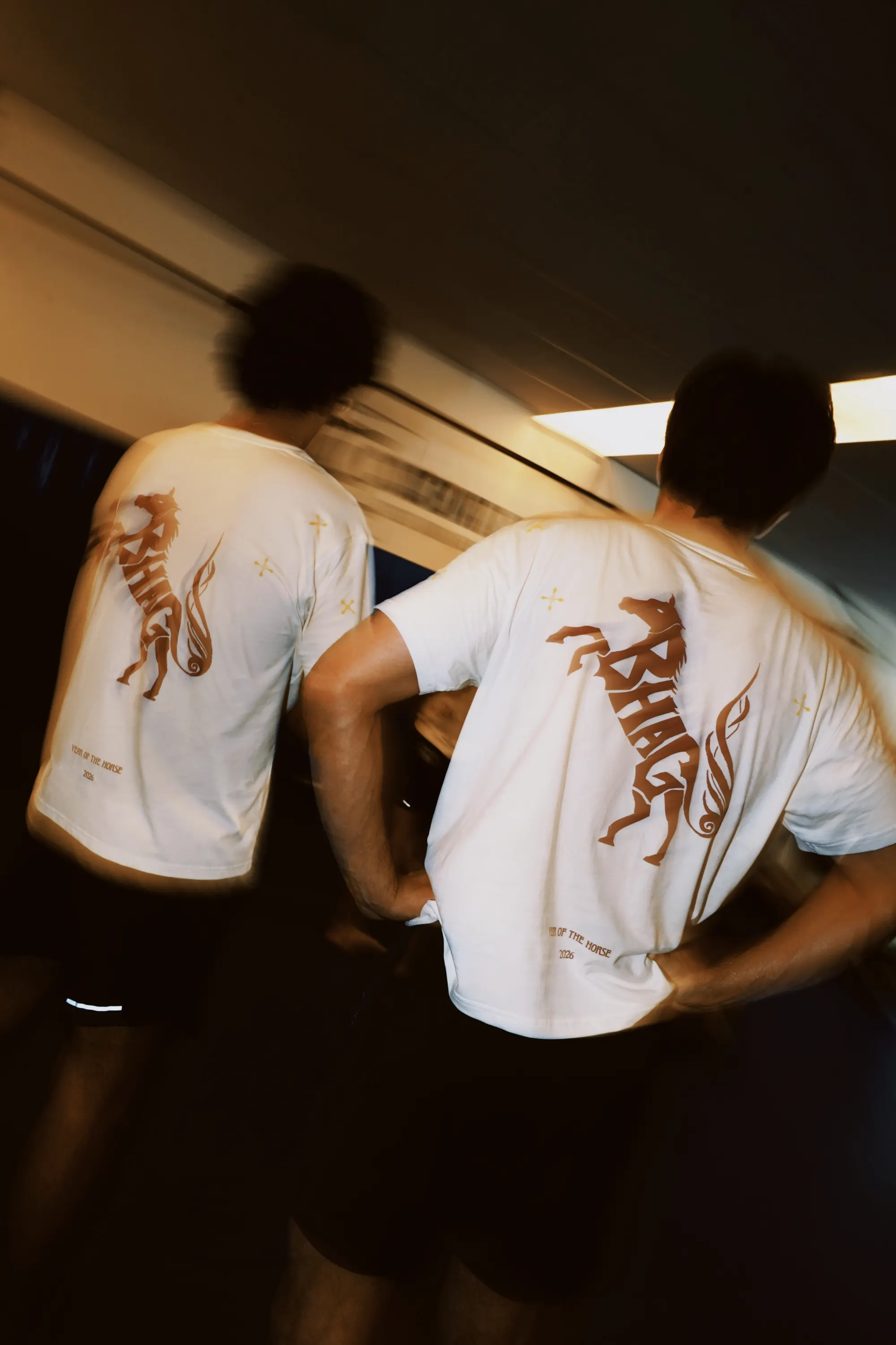 Two Wild Strides Tees in Ivory, both backs