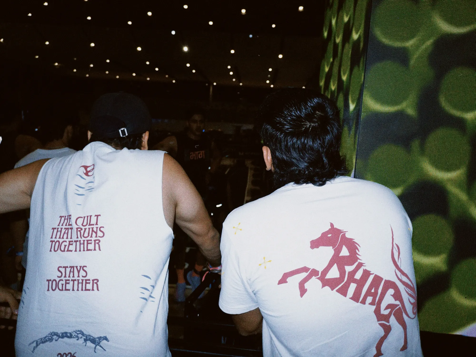 Wild Strides Tee in Ivory and the भाग Muscle Tank, both backs