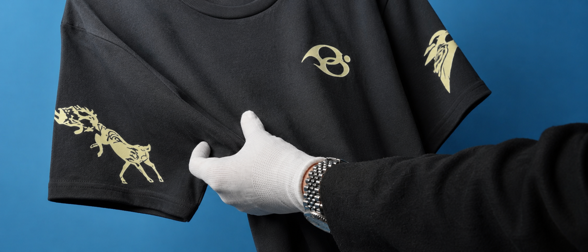 The Wild Strides Tee in Ash on the blue set - the Ghoda chest mark and the horse sleeve print